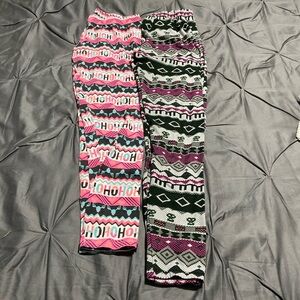 2 pair of Christmas stretch pants. Multi colors. Size M & a one size fits (m-l)